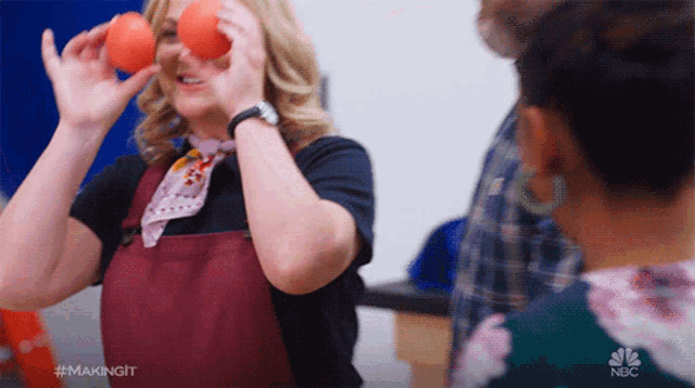 a woman holding two tomatoes in front of her eyes with the hashtag #makingit on the bottom