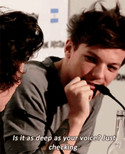 a man speaking into a microphone with the words is it as deep as your voice just checking