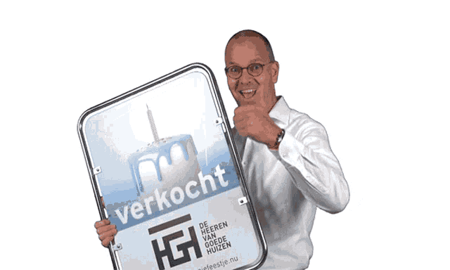 a man is holding a sign that says verkocht on it