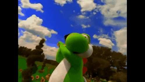 a green and white stuffed animal is standing in a field of sunflowers with a blue sky in the background .