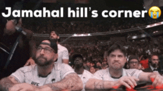 a group of men sitting in a stadium with the words jamahal hill 's corner on the top