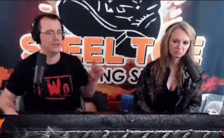 a man and a woman are sitting in front of microphones in front of a sign that says steel kings .