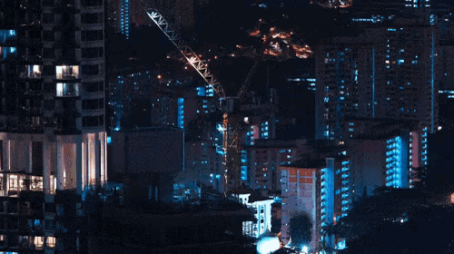 a construction crane is in the middle of a city