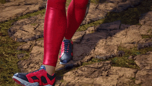 a person wearing red leggings and red shoes walking on a rocky path