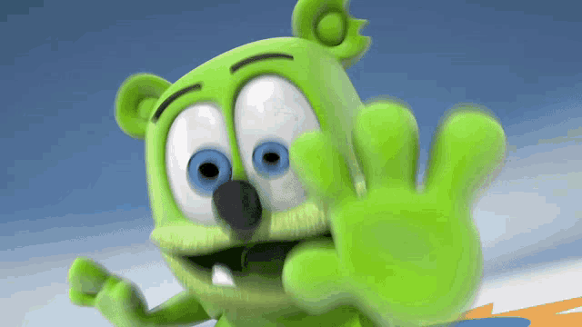 a green gummy bear with blue eyes waves his hand