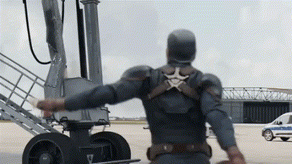 a man in a captain america costume is standing in front of a plane with his arms outstretched .