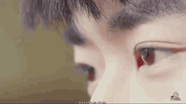 a close up of a man 's eye with a red eye .