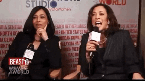 two women are talking into microphones in front of a sign that says ' beast tv women of the world '