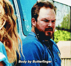 a man with a beard is talking to a woman and says body by butterfinger