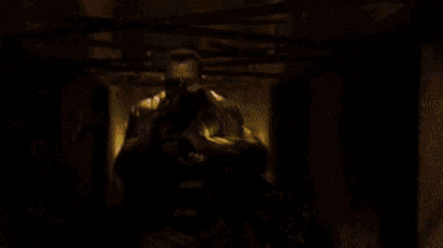 a man in a yellow jacket is holding a gun