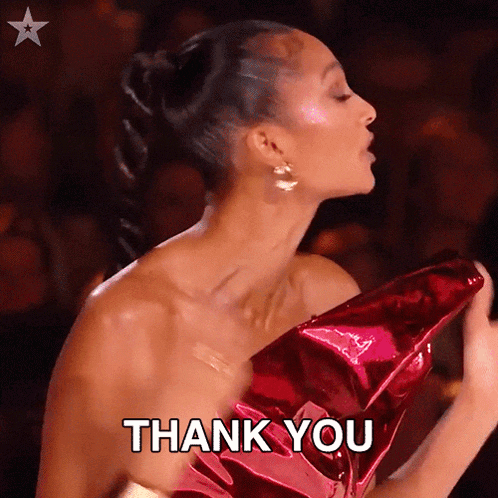 a woman in a red dress is giving a thank you sign