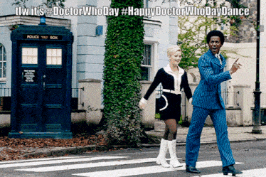 a man and a woman crossing a street in front of a police box