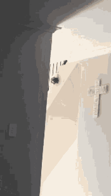 a staircase with a cross on the wall that says welcome