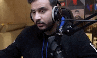 a man with a beard is wearing headphones and a microphone .