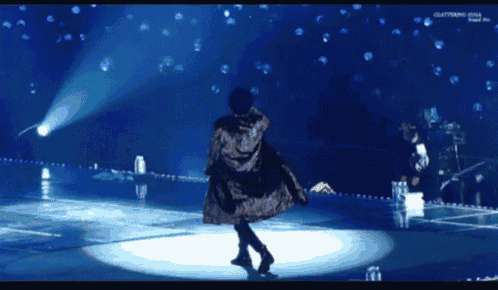 a person is dancing on a stage with the word clattering on the bottom right