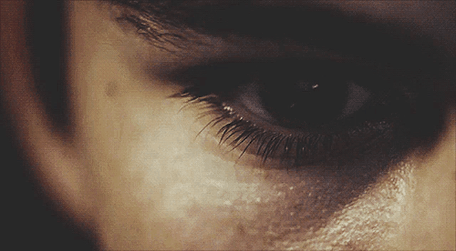 a close up of a person 's eye with a few lashes
