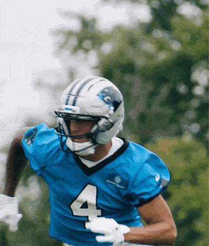a football player wearing a blue jersey with the number 4