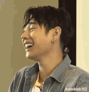 a close up of a person 's face with a laughing expression .