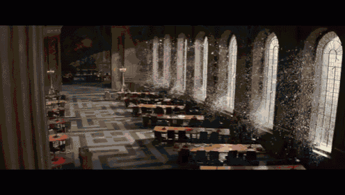 a large room with lots of tables and windows has a maze pattern on the floor