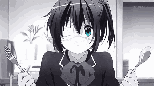a girl is holding a fork and spoon in her hands .