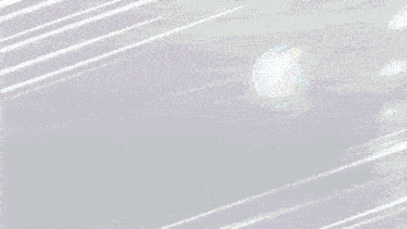 a blurred image of two balls flying through the air .
