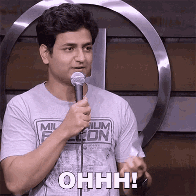 a man is holding a microphone and saying ohhh