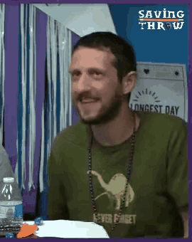 a man wearing a green shirt that says " never forget "