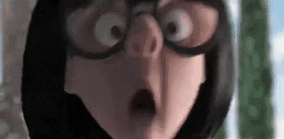 a close up of a cartoon character wearing glasses and a surprised look on her face .