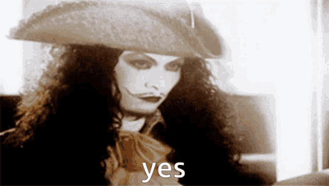 a woman wearing a hat says yes in a black and white photo