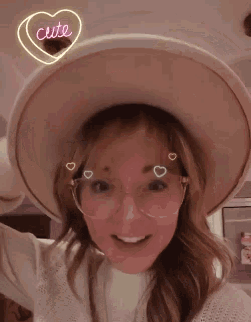 a woman wearing a hat and glasses with a neon heart that says cute .