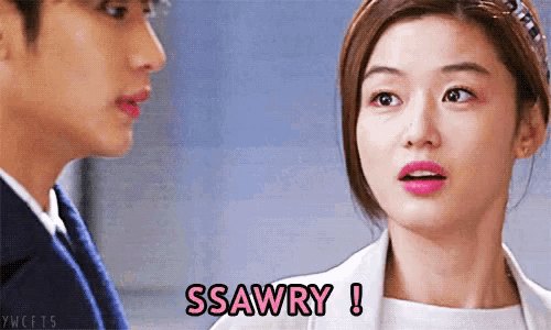 a woman says ssawry while looking at a man in a suit