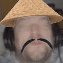 a man with a straw hat and a mustache is wearing a straw hat .