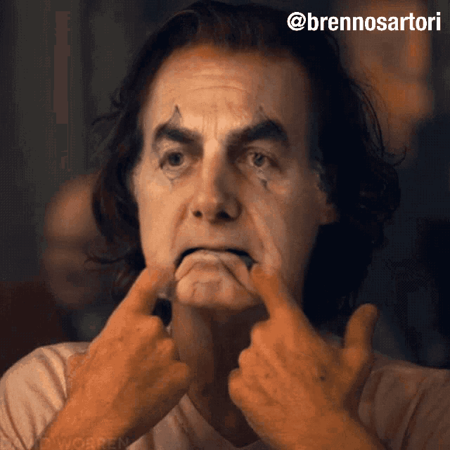 a man with joker makeup on his face is making a face