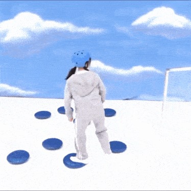a girl wearing a blue helmet is standing in front of a blue sky