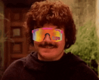 a man with a mustache is wearing sunglasses and a wig .