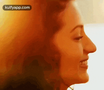 a close up of a woman 's face with her eyes closed and her mouth open .