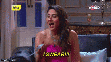 a woman in a pink dress is sitting on a couch with her mouth open and says i swear .