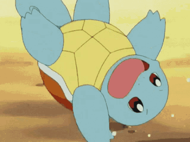 a cartoon squirtle is laying on its back in the sand .