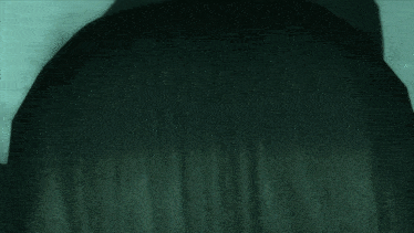 a close up of a person 's head with a gray background