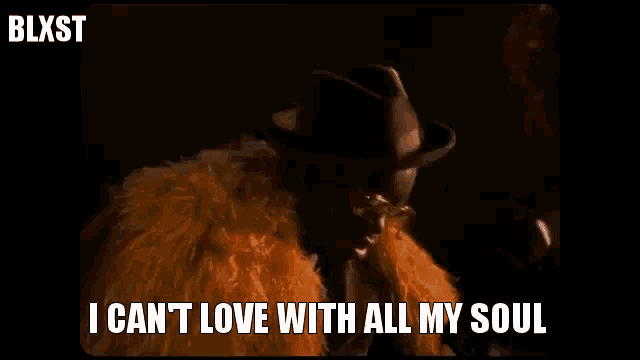 a man wearing a fur coat and a hat is saying i can 't love with all my soul .