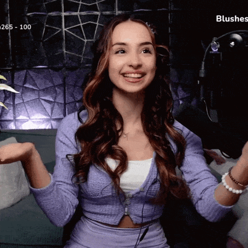a woman sitting on a couch with the words blushes visible