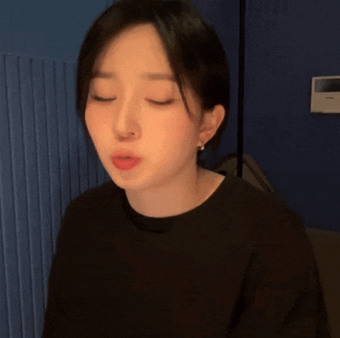 a close up of a woman making a funny face with her eyes closed