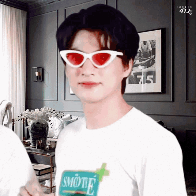 a man wearing sunglasses and a shirt with smotie on it