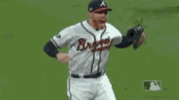 a baseball player wearing a braves jersey is standing on the field