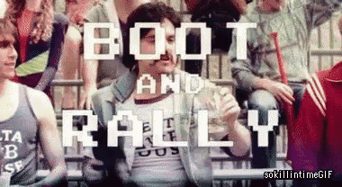 a group of people sitting in a stadium with the words boot and rally on the screen