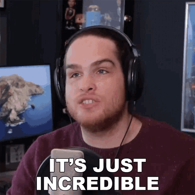 a man wearing headphones says " it 's just incredible " in front of a microphone