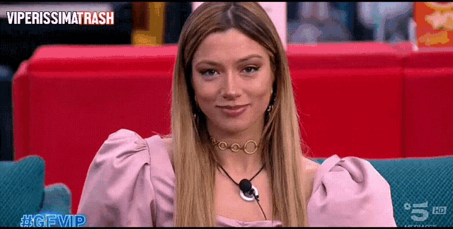 a woman is sitting on a couch with the hashtag #gfvip on the bottom right