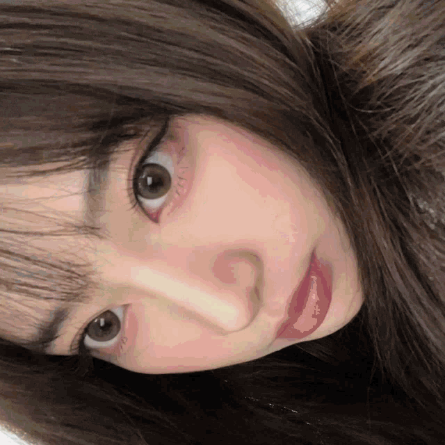 a close up of a woman 's face shows her eyes and red lips