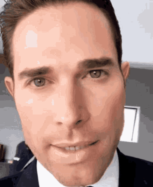 a close up of a man 's face with his mouth open