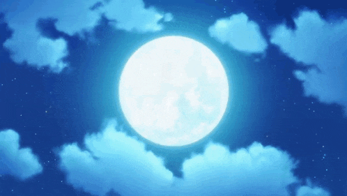 a full moon in a blue sky with clouds